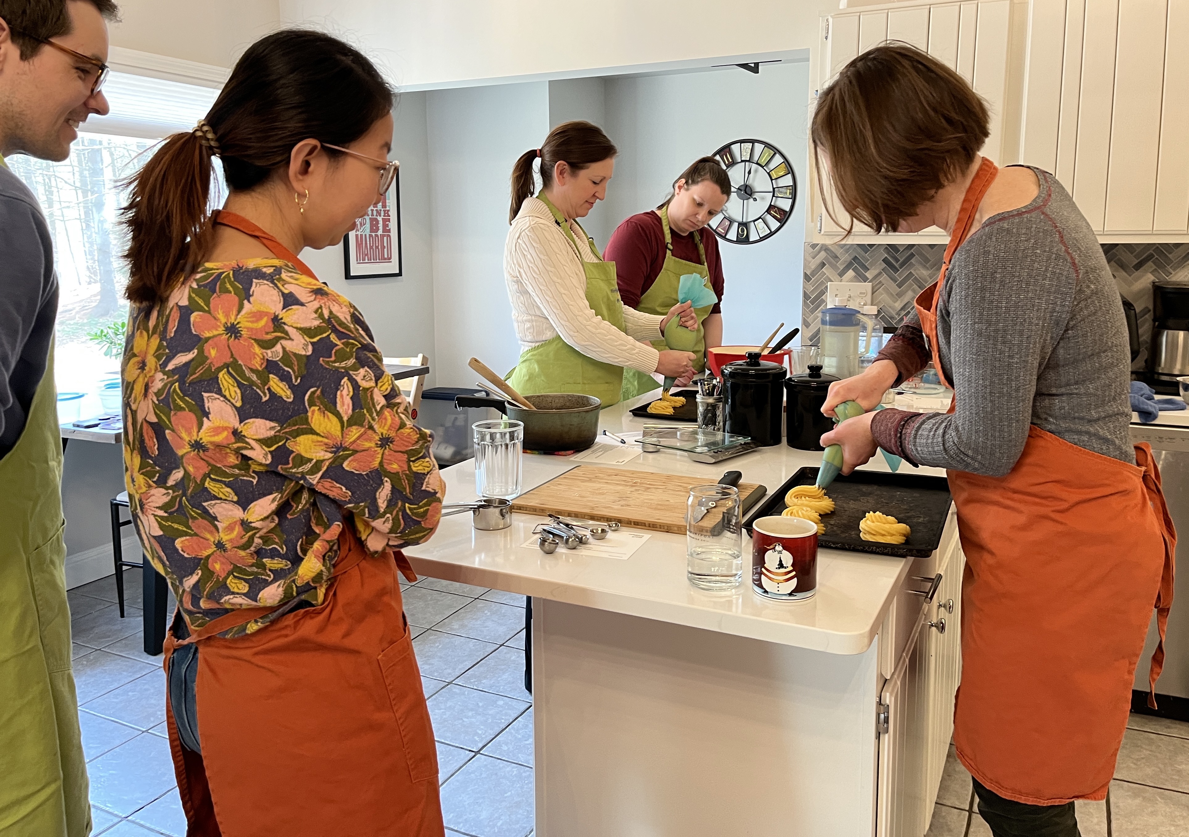 Neighbors gathered around kitchen counter during a hands-on workshop